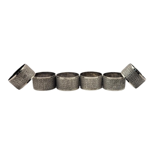 6 - BRIAN LESLIE FULLER, A SET OF SIX MID CENTURY SILVER SERVIETTE RINGS
Having a textured bark effect, ... 