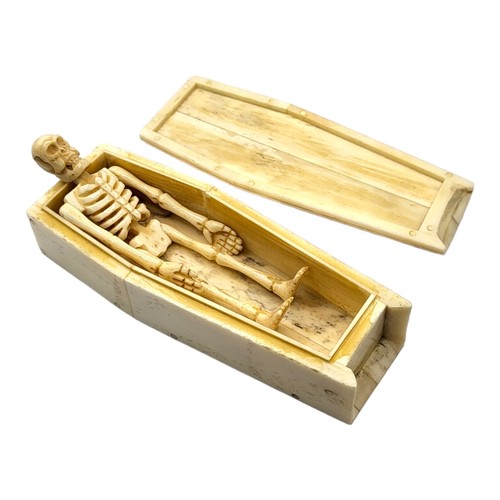 316A - A 19TH CENTURY STYLE BONE SCRIMSHAW TRINKET BOX
In shape of a coffin, with etched whaling scene to l... 