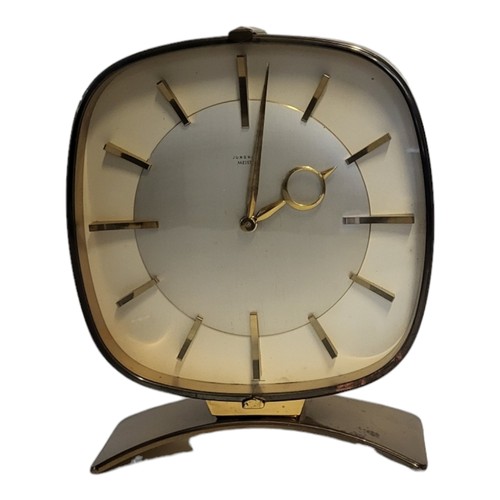 221B - JUNGHANS, A MID CENTURY GILT BRASS MANTLE CLOCK
Oval case with mechanical movement and arched base.
... 