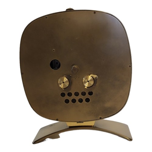 221B - JUNGHANS, A MID CENTURY GILT BRASS MANTLE CLOCK
Oval case with mechanical movement and arched base.
... 