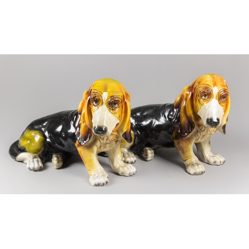 108 - A PAIR OF MID-20TH CENTURY LIFE-SIZE GLAZED CERAMIC BASSET HOUND DOG SCULPTURES.
(h 41cm x w 63cm x ... 