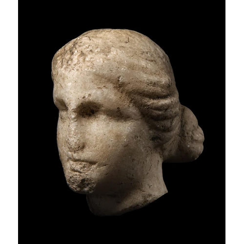 81 - A FRAGMENTARY MARBLE HEAD OF A GODDESS.
Probably Greek, circa 1st – 2nd century AD.
On a custom stan... 