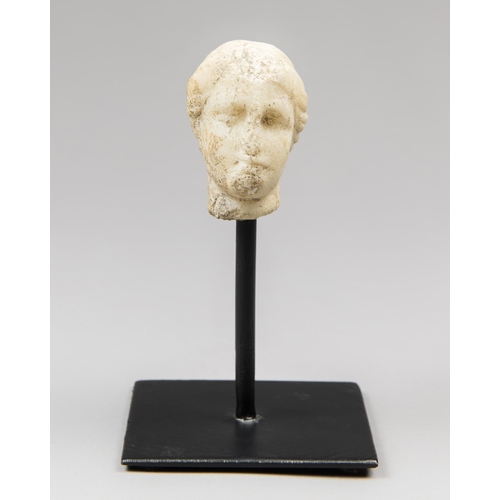 81 - A FRAGMENTARY MARBLE HEAD OF A GODDESS.
Probably Greek, circa 1st – 2nd century AD.
On a custom stan... 