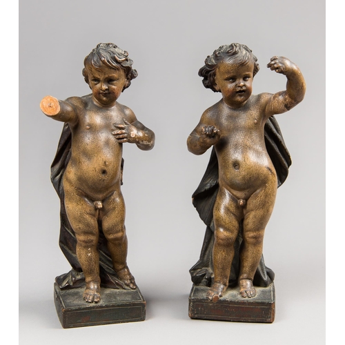 89 - A PAIR OF 17TH/18TH CENTURY FINELY POLYCHROME PAINTED WOODEN PUTTI.
(h 21.5cm). Note: The original d... 