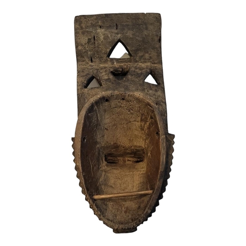 403 - AN AFRICAN TRIBAL CARVED WOODEN BAULE PORTRAIT MASK
Having four producing legs to finial and pierced... 