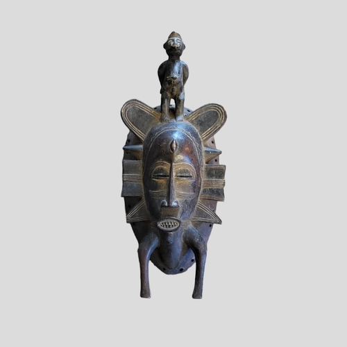 407 - AN AFRICAN TRIBAL CARVED WOODEN SENUFO PASSPORT MASK
Having a figural finial and carved decoration.
... 