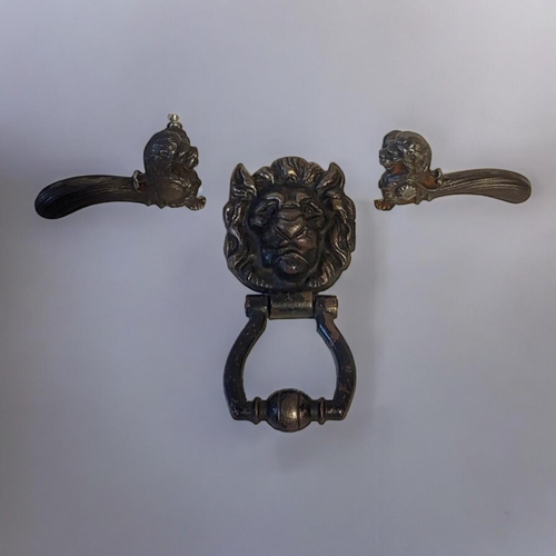 435 - A PAIR OF 19TH CENTURY CAST IRON LION MASK DOOR HANDLES
Opposing lions with flutes to handle, togeth... 