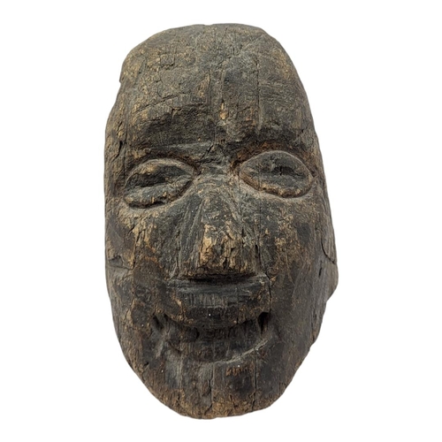 444 - A 19TH CENTURY CONTINENTAL CARVED WOODEN HEAD
Elongated form with carved features.
(approx 20cm x 15... 