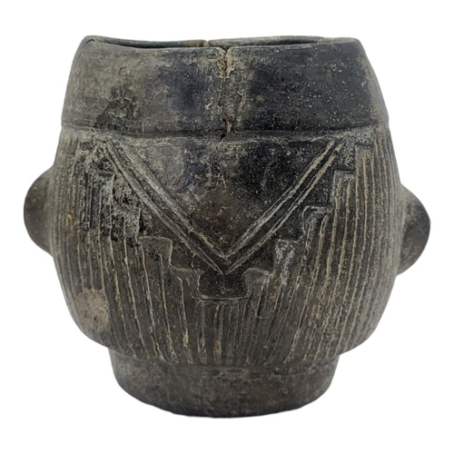 446 - A SOUTH AMERICAN POTTERY FIGURAL VESSEL
Having a grimacing face to body and reeds to headdress.
(app... 