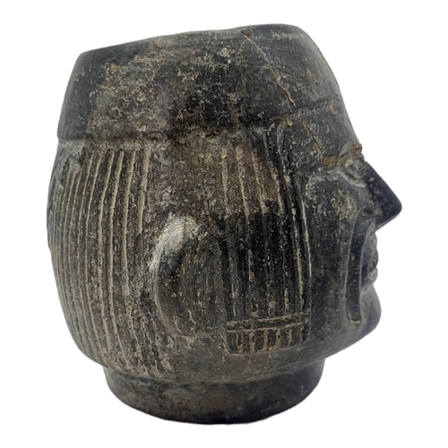 446 - A SOUTH AMERICAN POTTERY FIGURAL VESSEL
Having a grimacing face to body and reeds to headdress.
(app... 