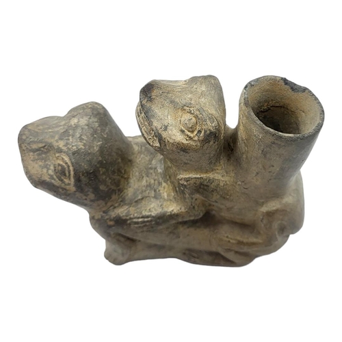 452 - A SOUTH AMERICAN POTTERY EROTIC VESSEL
Two toads with cylindrical spout.
(approx 16cm)

Condition: c... 