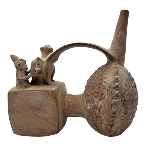 456 - A SOUTH AMERICAN TERRACOTTA POTTERY WHISTLING JAR
Trumpet form finial with seated figure with lama.
... 