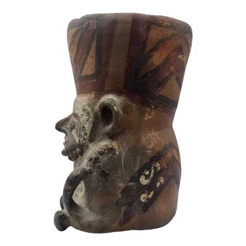 457 - A SOUTH AMERICAN TERRACOTTA POTTERY MASK JUG
Having facial mask, single handle with hand painted dec... 