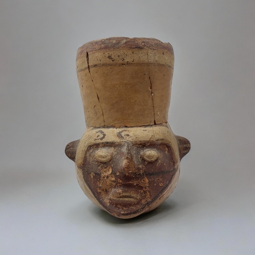 458 - A SOUTH AMERICAN TERRACOTTA POTTERY MASK JUG
Carved facial features with painted decoration.
(approx... 