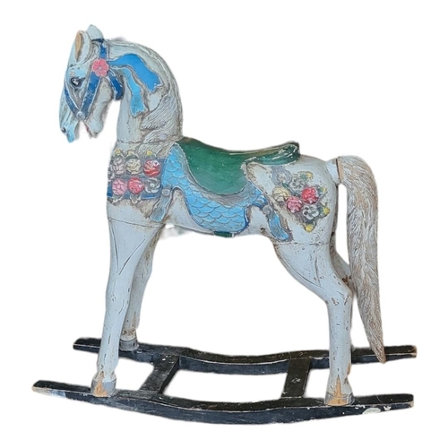 461 - A CARVED WOODEN CHILD'S ROCKING HORSE
In cream painted finish with floral decoration.
(124cm x 36cm ... 