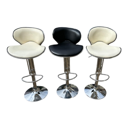 465 - A PAIR OF CREAM LEATHER AND CHROME ADJUSTABLE BAR STOOLS
Along with another in black.
(84cm, extende... 