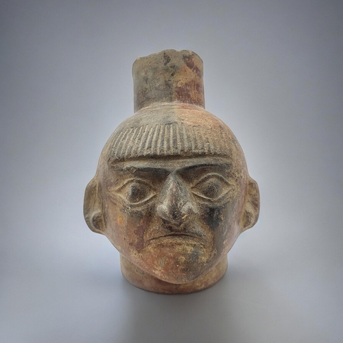 471 - A SOUTH AMERICAN TERRACOTTA POTTERY FACE MASK JUG
Spout form finial with mask to body.
(approx 18cm)... 