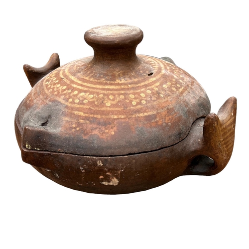 473 - A SOUTH AMERICAN TERRACOTTA POTTERY COOKING POT AND COVER
Twin animal mask handles and painted decor... 