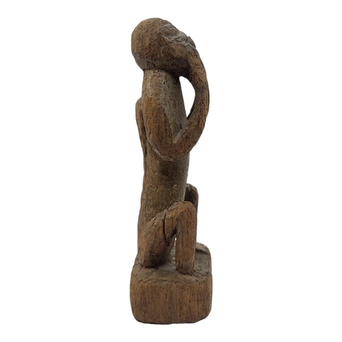 477 - AN AFRICAN CAMEROON CARVED WOODEN FIGURE
Seated pose with hands to mouth.
(approx 21cm)
 
Condition:... 