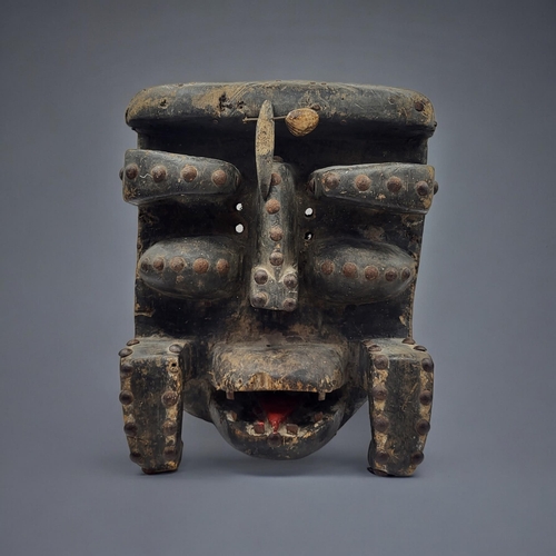 479 - A SOUTH AMERICAN CARVED WOODEN MASK
Protruding features with iron studs to edges.
(approx 21cm x 26c... 