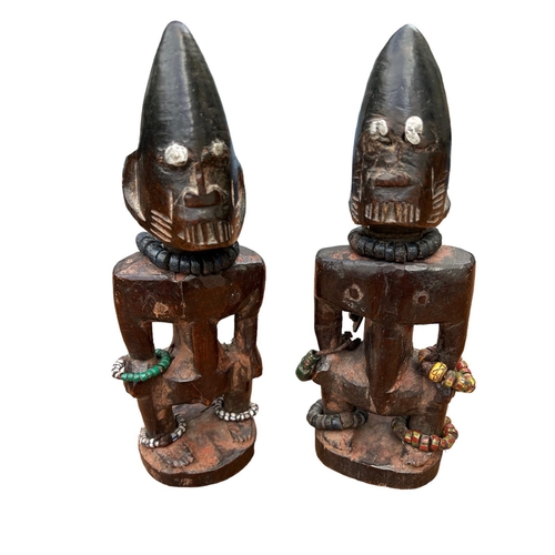 482 - A PAIR OF AFRICAN YORUBA CARVED WOODEN FERTILITY FIGURES
Male and female with steel nails to eyes an... 