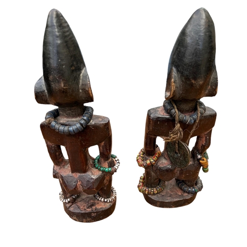 482 - A PAIR OF AFRICAN YORUBA CARVED WOODEN FERTILITY FIGURES
Male and female with steel nails to eyes an... 