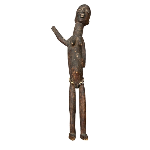 483 - AN AFRICAN LOBI/GHANA CARVED WOODEN FIGURE
Elongated female form with one arm raised and shells to w... 