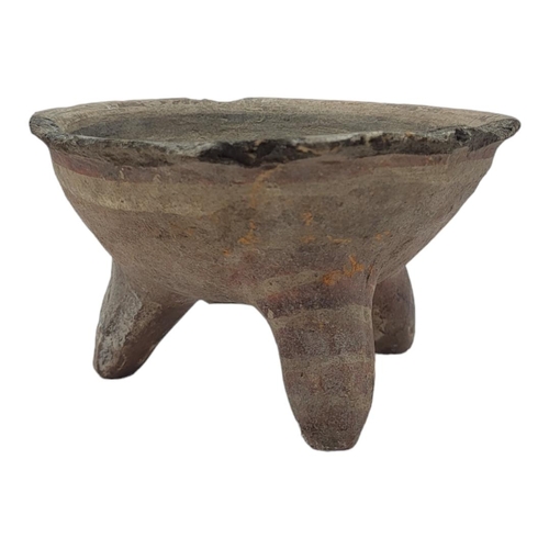 487 - A SOUTH AMERICAN POTTERY CONICAL TRIPOD BOWL
Hand painted with concentric rings on tripod legs.
(app... 