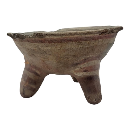 487 - A SOUTH AMERICAN POTTERY CONICAL TRIPOD BOWL
Hand painted with concentric rings on tripod legs.
(app... 