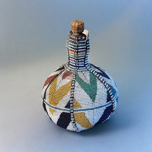 428 - A 20TH CENTURY AFRICAN BEADED GOURD BOTTLE
Having a colourful arrangement of glass beads with cork.
... 