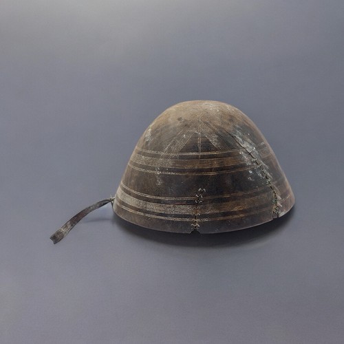 430 - AN AFRICAN CARVED WOODEN TOUAREG BOWL
Conical form, with incised decoration and brass mounts to hand... 