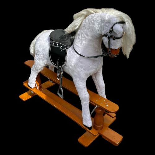 462 - A CHILD'S SOFT GREY FUR ROCKING HORSE
With leather saddle on a pine base.
(140cm x 46cm x h 108cm)

... 