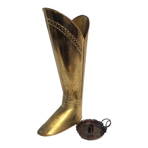 468 - A BRASS BOOT STICK STAND 
Along with an Arts and Crafts copper chamber stick.
(tallest 55cm)