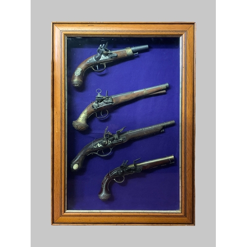 192A - A COLLECTION OF IMITATION ANTIQUE PISTOLS IN A GLAZED FRAMED CASE.
(h 83cm x w 57cm x d 9cm)