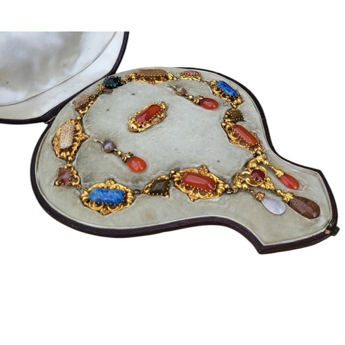 101 - A 19TH CENTURY YELLOW METAL, CARNELIAN AND SPECIMEN HARDSTONE JEWELLERY SUITE
Comprising a necklace ... 