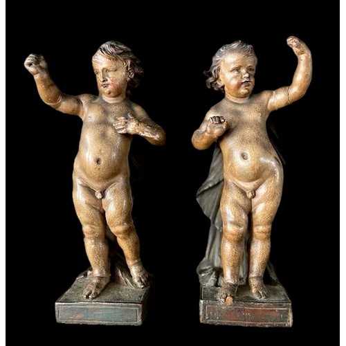 89 - A PAIR OF 17TH/18TH CENTURY FINELY POLYCHROME PAINTED WOODEN PUTTI.
(h 21.5cm). Note: The original d... 