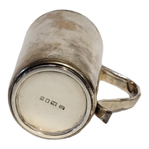 11 - A SOLID SILVER TANKARD OF PLAIN DESIGN
With hollow handle, London, 1973, by J.R.N., engraved to one ... 