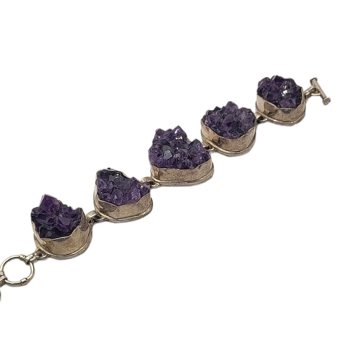 116 - A VINTAGE SILVER AND AMETHYST BRACELET
Five amethyst rock clusters in collet silver mount.
(approx 3... 