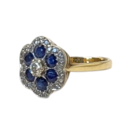 135 - A VINTAGE 18CT GOLD DIAMOND AND SAPPHIRE CLUSTER RING
Having an arrangement of round cut stones form... 