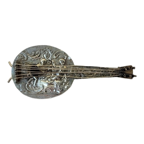 136A - A VINTAGE CONTINENTAL SILVER NOVELTY MANDOLIN
Having embossed figural decoration and scrolled stand ... 