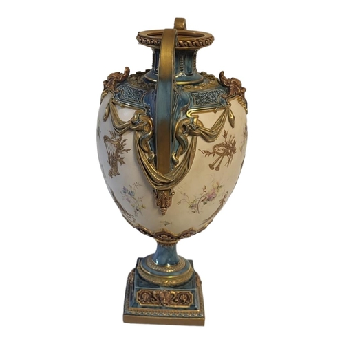 177 - ROYAL WORCESTER, A LOUIS XVI ROCOCO STYLE JEWELLED TWIN HANDLED CENTREPIECE VASE
On square polished ... 