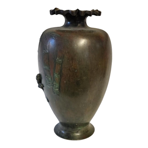 192 - A JAPANESE MEIJI PERIOD HEAVY BRONZE VASE
Decorated in relief with a tiger stalking through a bamboo... 