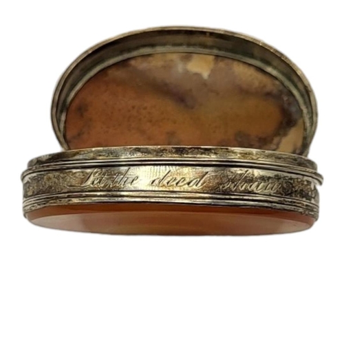 31 - A 19TH CENTURY WHITE METAL AND HARDSTONE OVAL SNUFF BOX
The frame engraved 'Let The Deed Shaw'.
(app... 