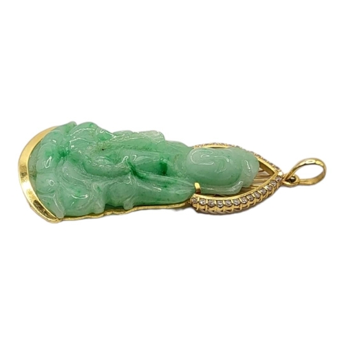 43 - A CHINESE 18CT GOLD, DIAMOND AND JADE PENDANT
Carved seated pose, edged with round cut diamonds, mar... 