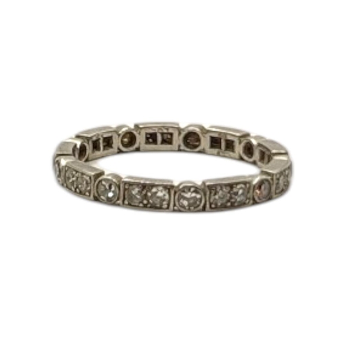 57 - A VINTAGE WHITE METAL AND DIAMOND FULL ETERNITY RING
Having an arrangement of round cut diamonds.

C... 