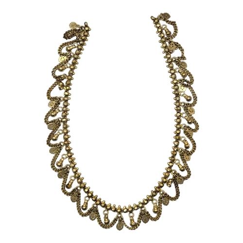 77 - AN EARLY 20TH CENTURY INDIAN YELLOW METAL NECKLACE
Pierced links with swags.
(approx 50cm)

Conditio... 