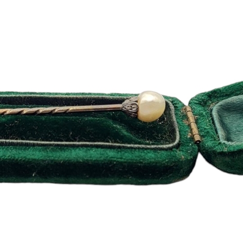 9 - A VICTORIAN WHITE METAL,DIAMOND AND PEARL STICK PIN
The single pearl edged with old cut stones, in a... 