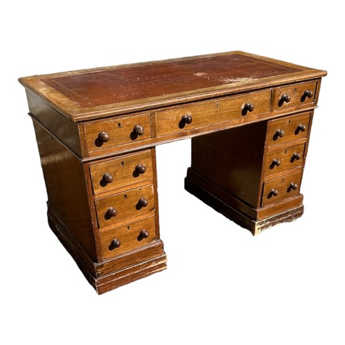 586 - A VICTORIAN MAHOGANY DESK
With tooled leather top above an arrangement of nine drawers.
(120cm x 65c... 