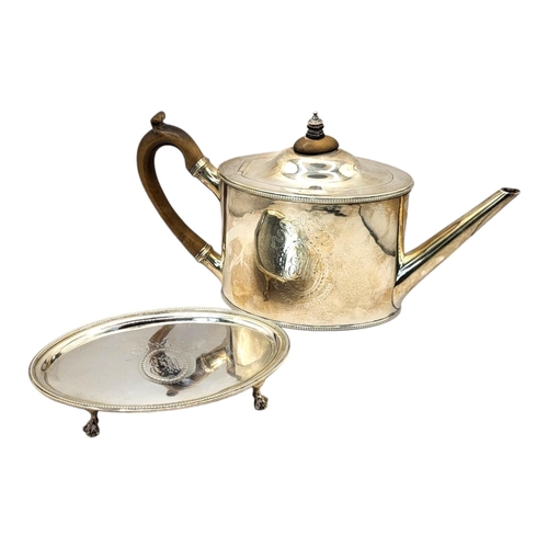 1 - A GEORGIAN SILVER OVAL TEAPOT AND STAND
With carved wood handle,finial and beaded edge ,the tray hav... 