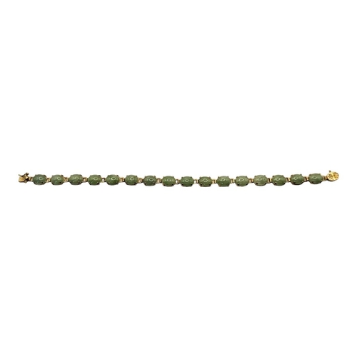 15 - A VINTAGE CHINESE 14CT GOLD AND JADE BRACELET
Having a row of cabochon cut stones with a pierced 14c... 